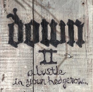 Down II album cover: the Down logo, a Roman numeral two and the words a bustle in your hedgerow painted in black on weathered grey wooden boards