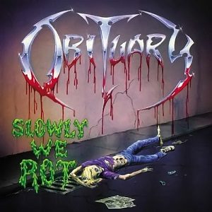Slowly We Rot cover: a rotting corpse in jeans and a purple shirt sprawled on a street beside a drain, under a chrome Obituary logo dripping blood and the album title in green slime letters